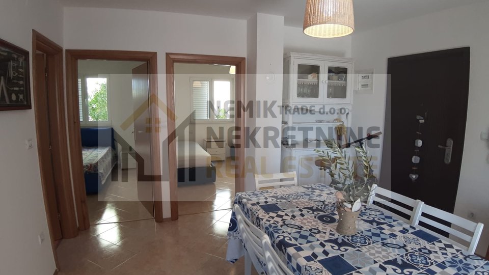 Vodice, two-bedroom apartment on the ground floor of a smaller residential building surrounded by greenery and a garden